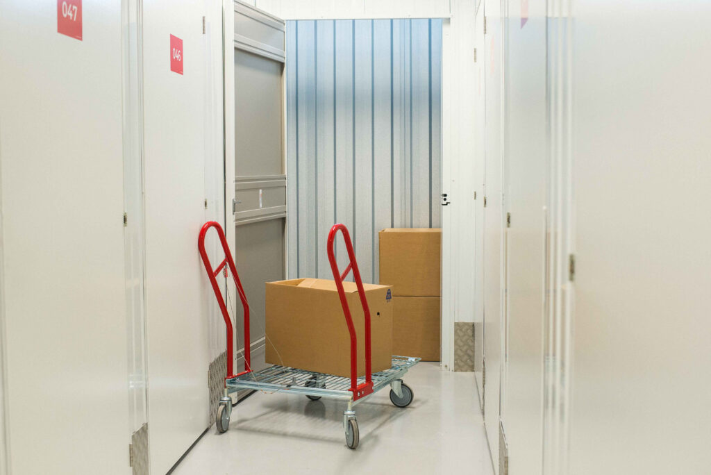 Three boxes and a trolley in a unit in a flexistore facility