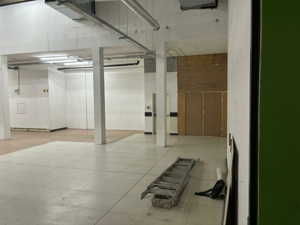 Interior of a self-storage facility in stellenbosch, featuring spacious tiled floors, visible ventilation systems, and secure storage access. Ideal for flexible storage solutions with flexistore.